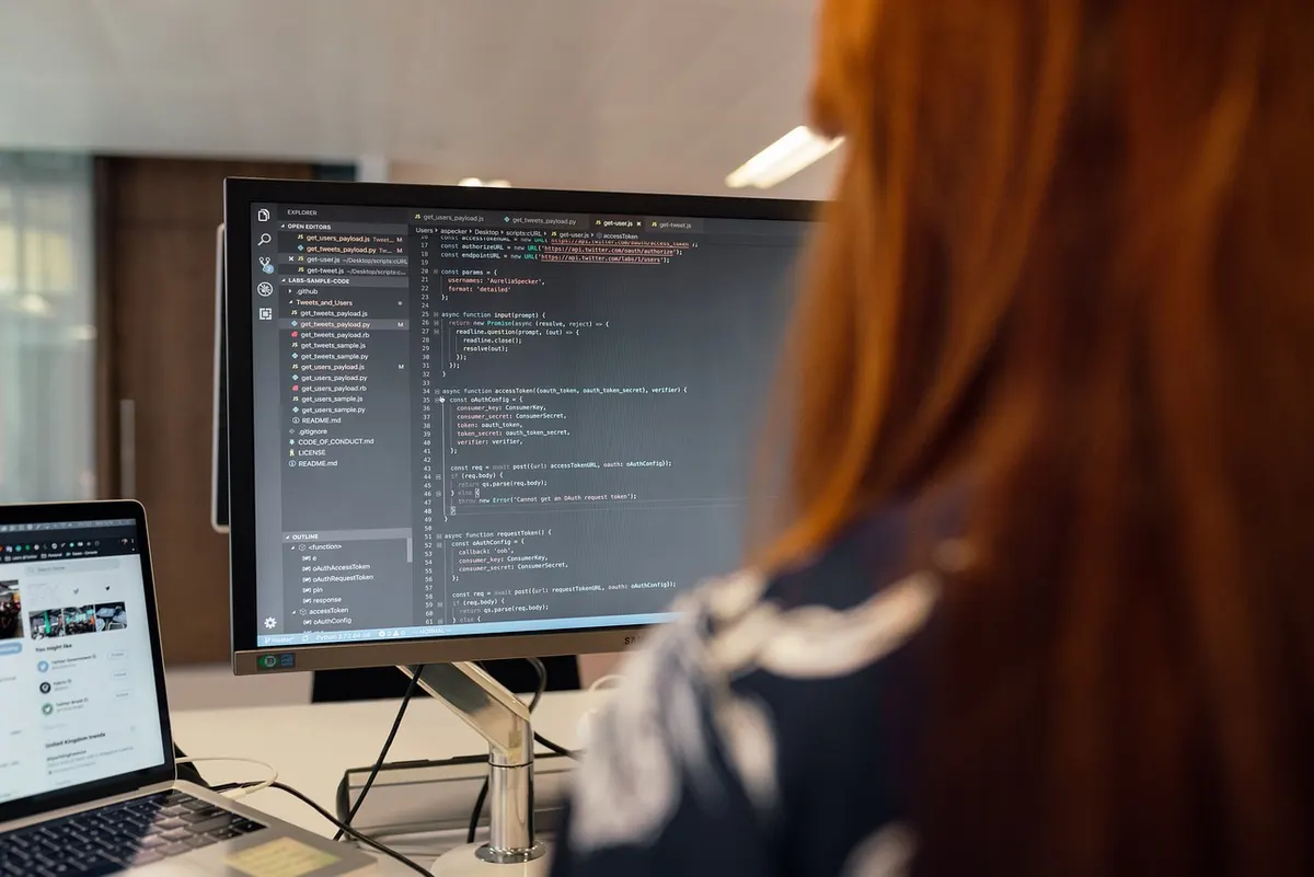 Angular Performance Optimization Frontend developer reviewing code on a monitor for Angular performance optimization