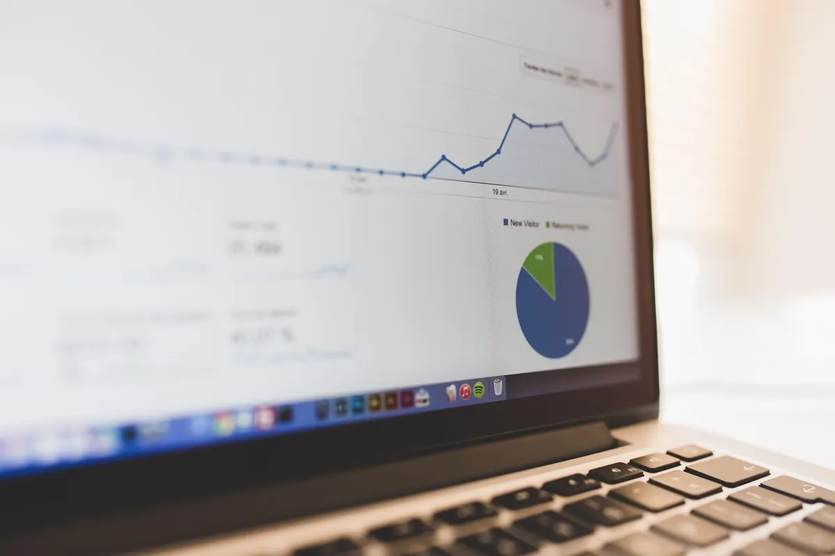 Laptop screen displaying an analytics dashboard for SQL query performance tuning