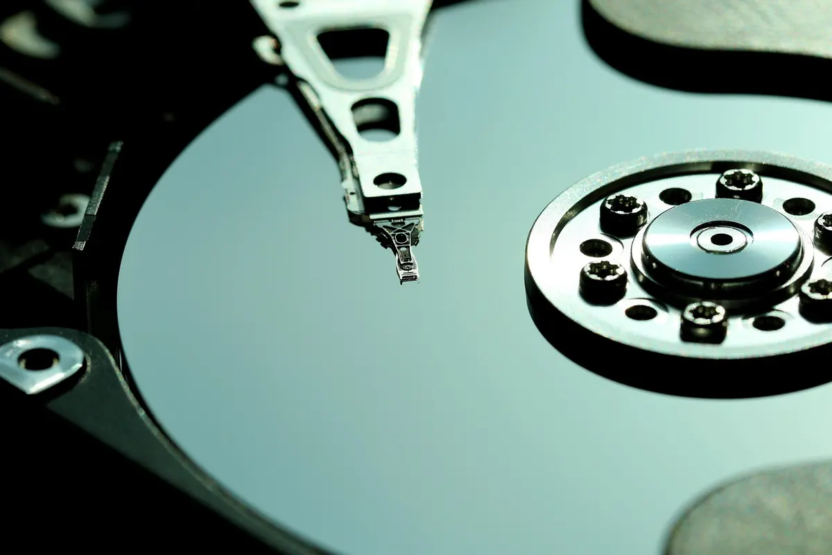 Close-up of a hard disk drive mechanism representing SQL Server database design